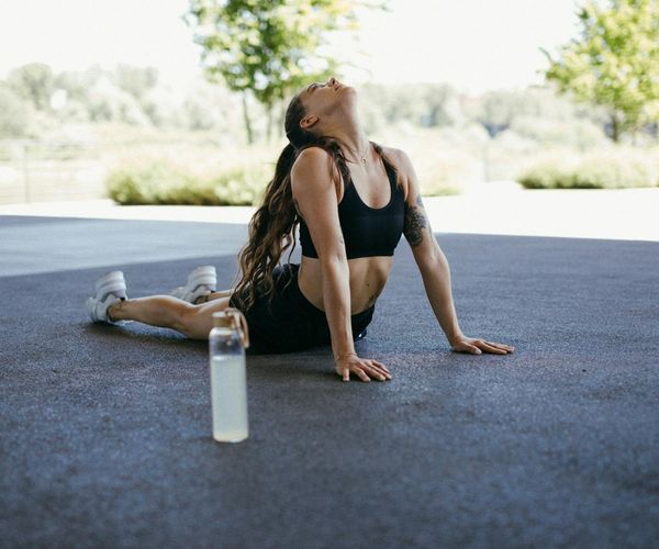 Person stretching in nature, feeling calm and strong.